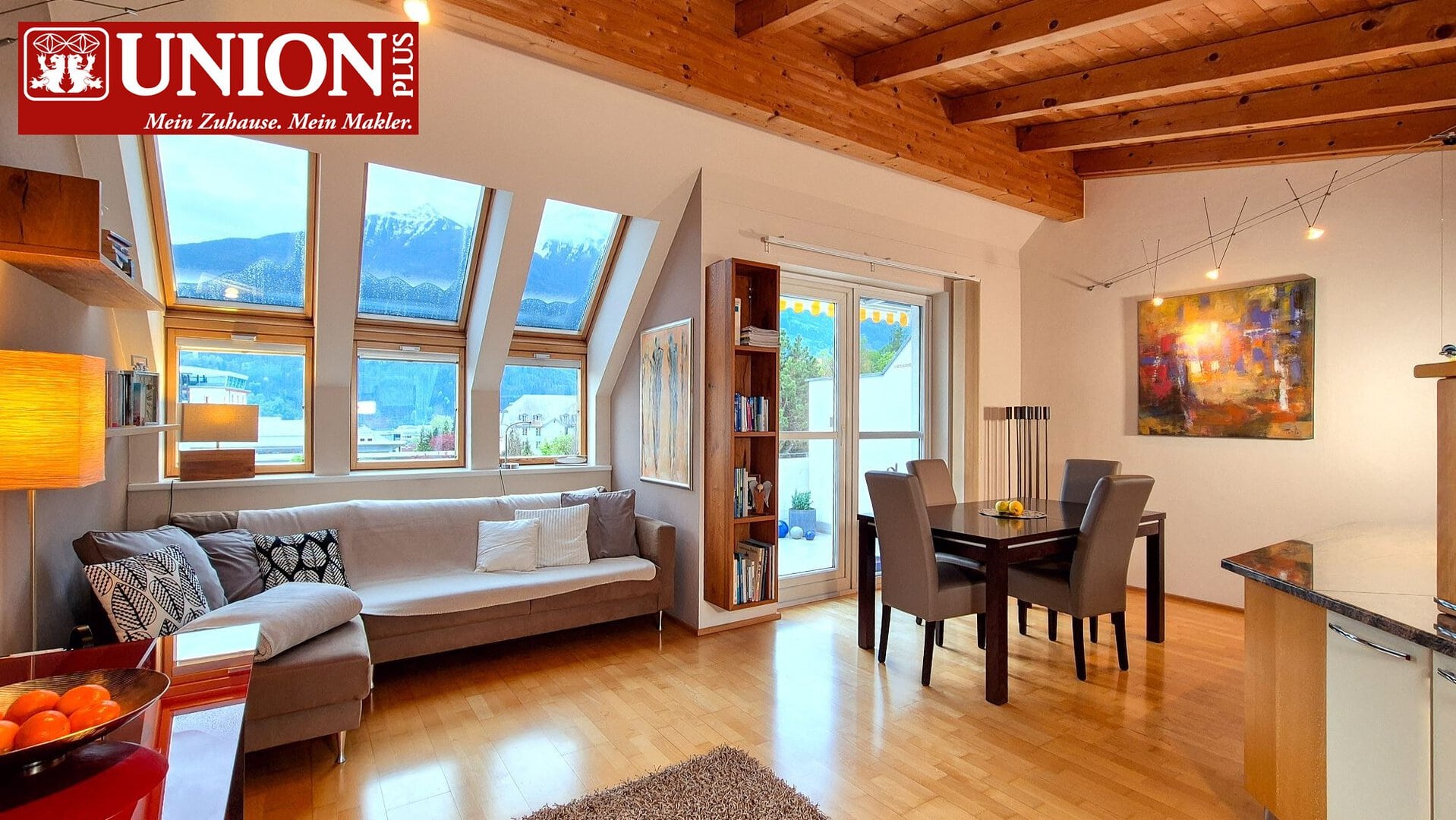 Gemütliche wohnung mit großen dachfenstern und bergblick, gemütliches interieur in einem modernen haus, essbereich und sofa im wohnzimmer, holzdecken und künstlerische beleuchtung, warmes licht, einladendes zuhause für familien und singles.